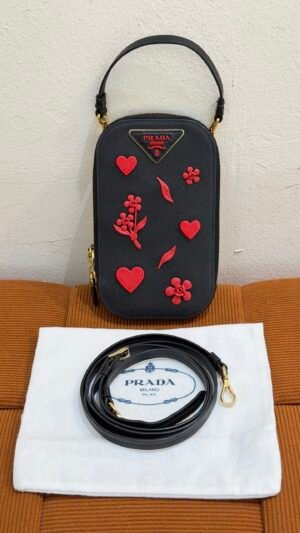 Pre-Owned/ Pre-Loved/ Second-Hand Prada Phone and Card Crossbody Carrier, Bag in Black, Red Charms, Gold Hardware Color, 10 x 18 x 2 cm Size, Front View