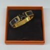 b202506586-hermes-clic-h-bracelet Pre-Owned/ Pre-Loved/ Second-Hand Hermes Clic H Bracelet, Bracelet in Black, Gold Color, PM (16cm wrist or smaller) Size, Front View